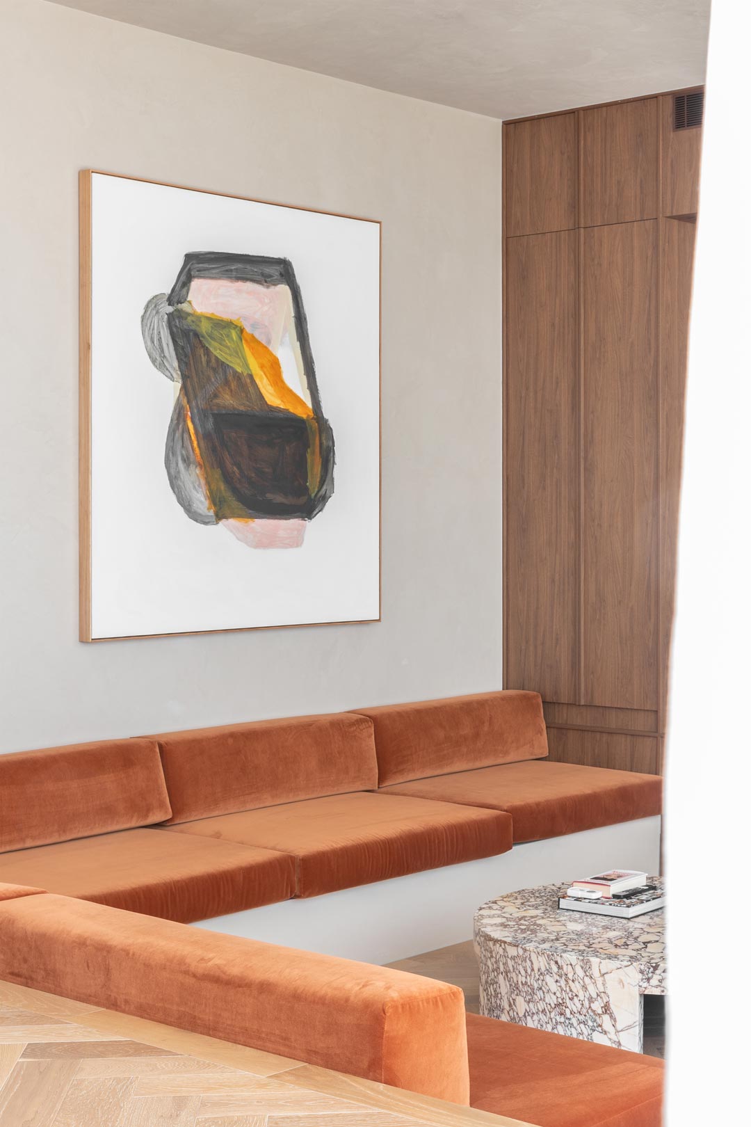 A-1970s-inspired-sunken-lounge-in-burnt-orange-velvet-with-dark-earthy-walnut-cabinetry