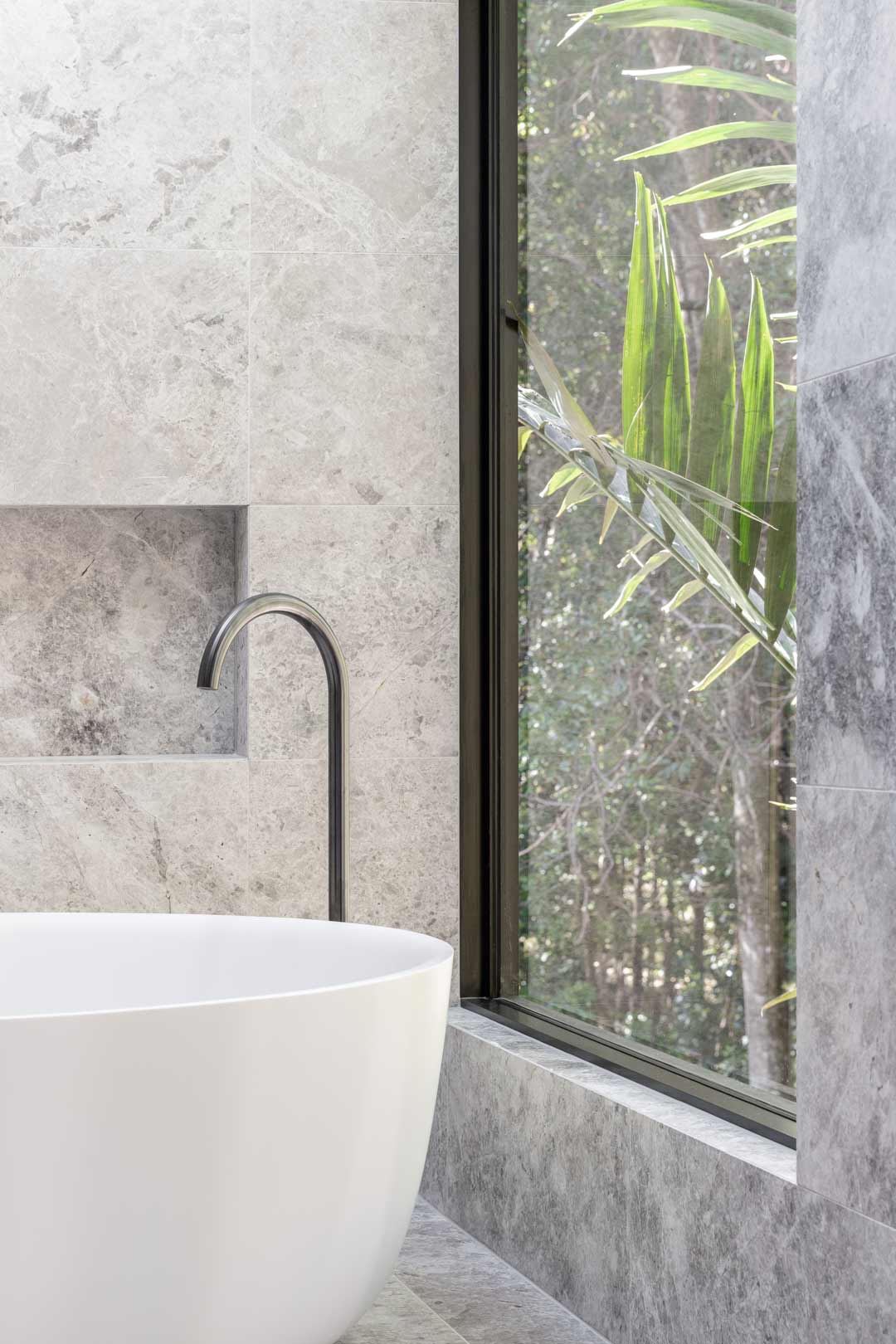 A-bath-surrounded-by-nature-in-a-monochromatic-industrial-style-alpine-lodge