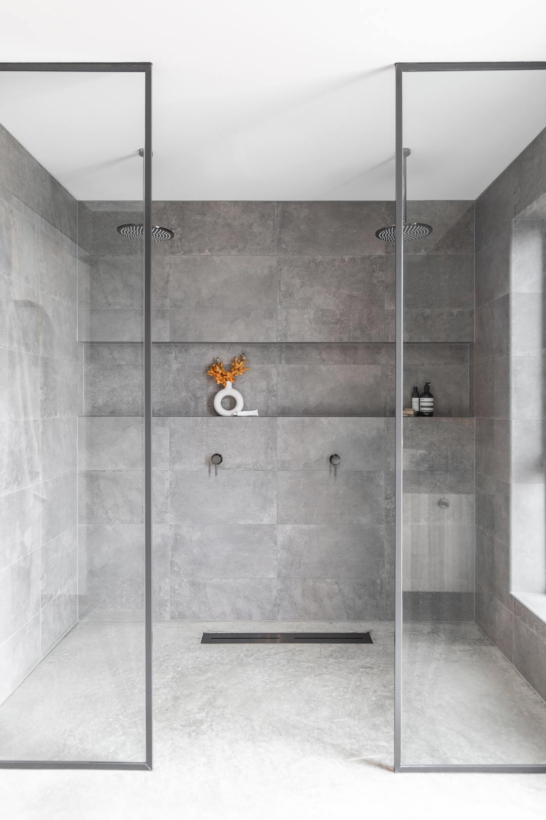 A-concrete-look-tile-and-concrete-floor-in-this-bathroom-design