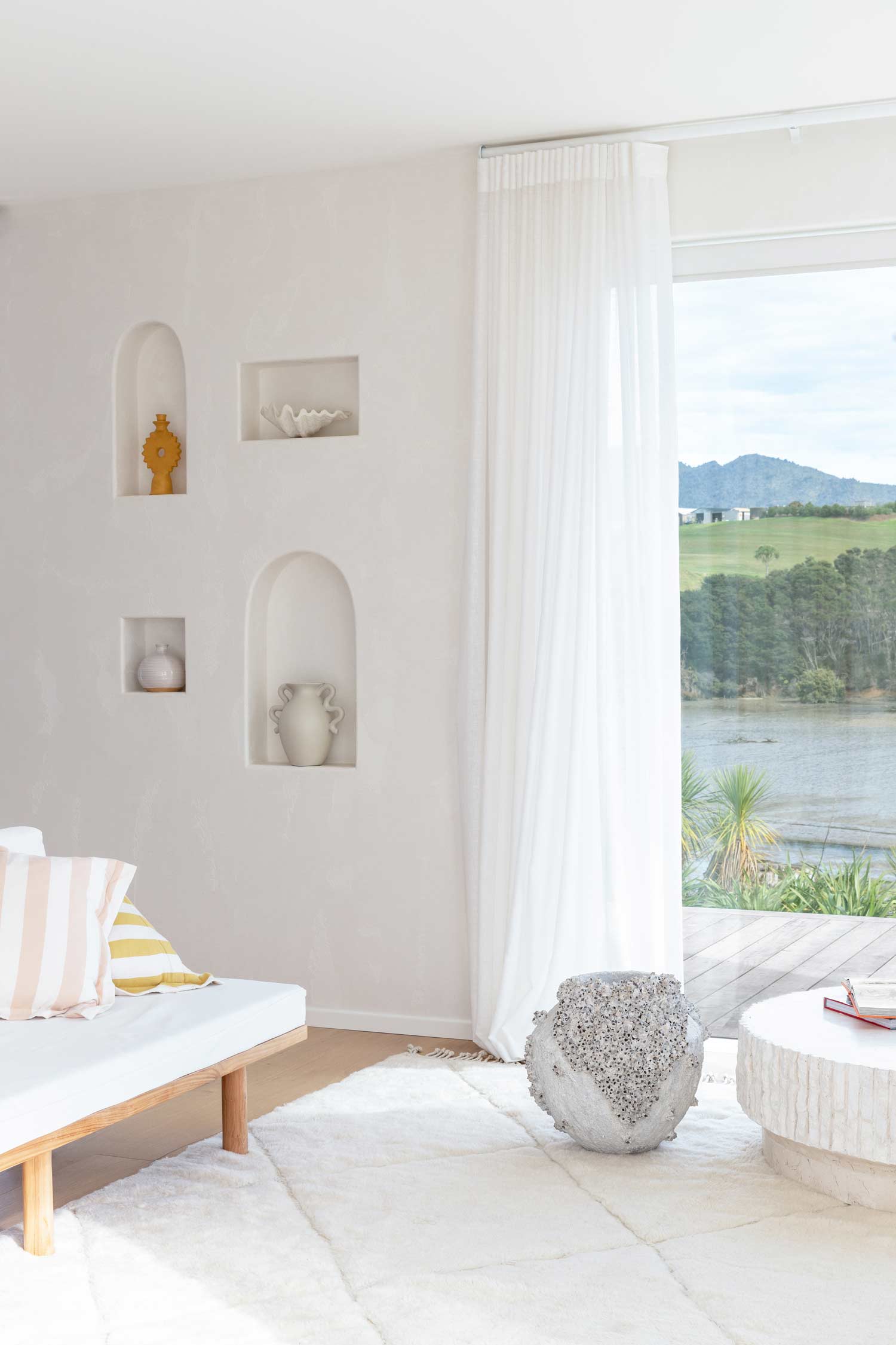 A-light-bright-moditerranean-living-room-with-a-neutral-colour-palette-and-a-styled-niche-wall