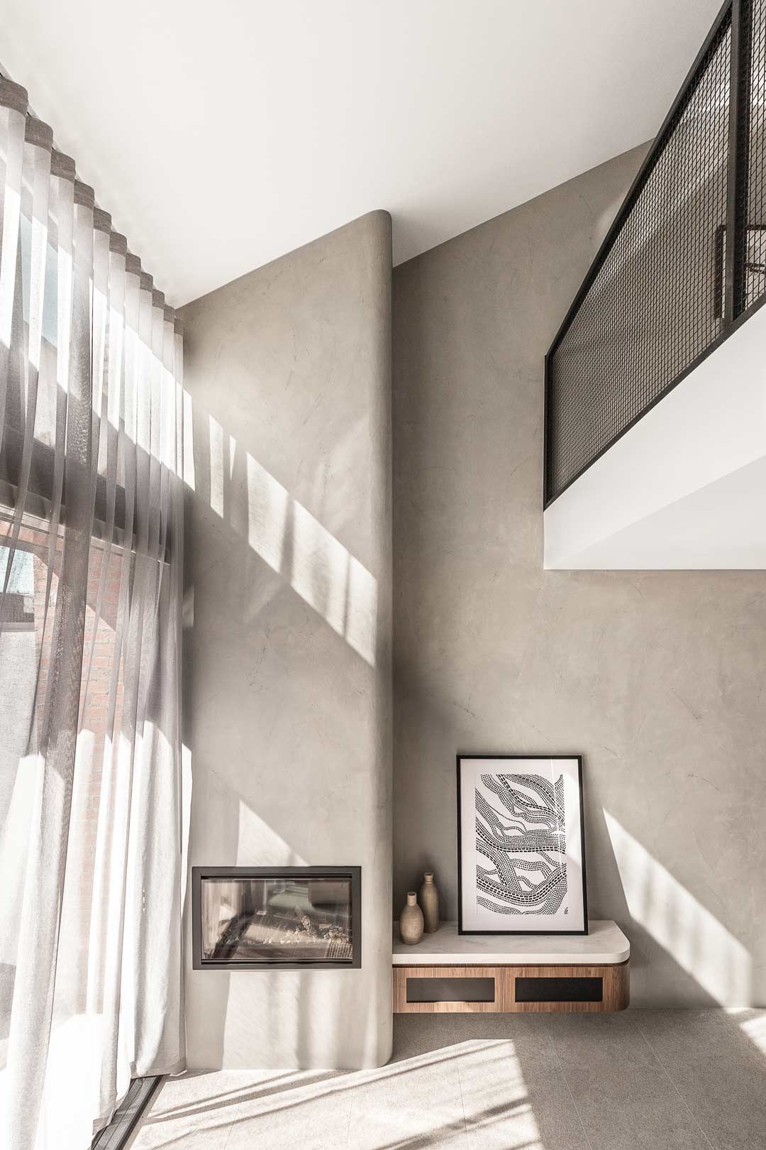 A-loft-style-living-room-in-an-industrial-style-Melbourne-home-with-textured-walls-and-a-mezzanine-level
