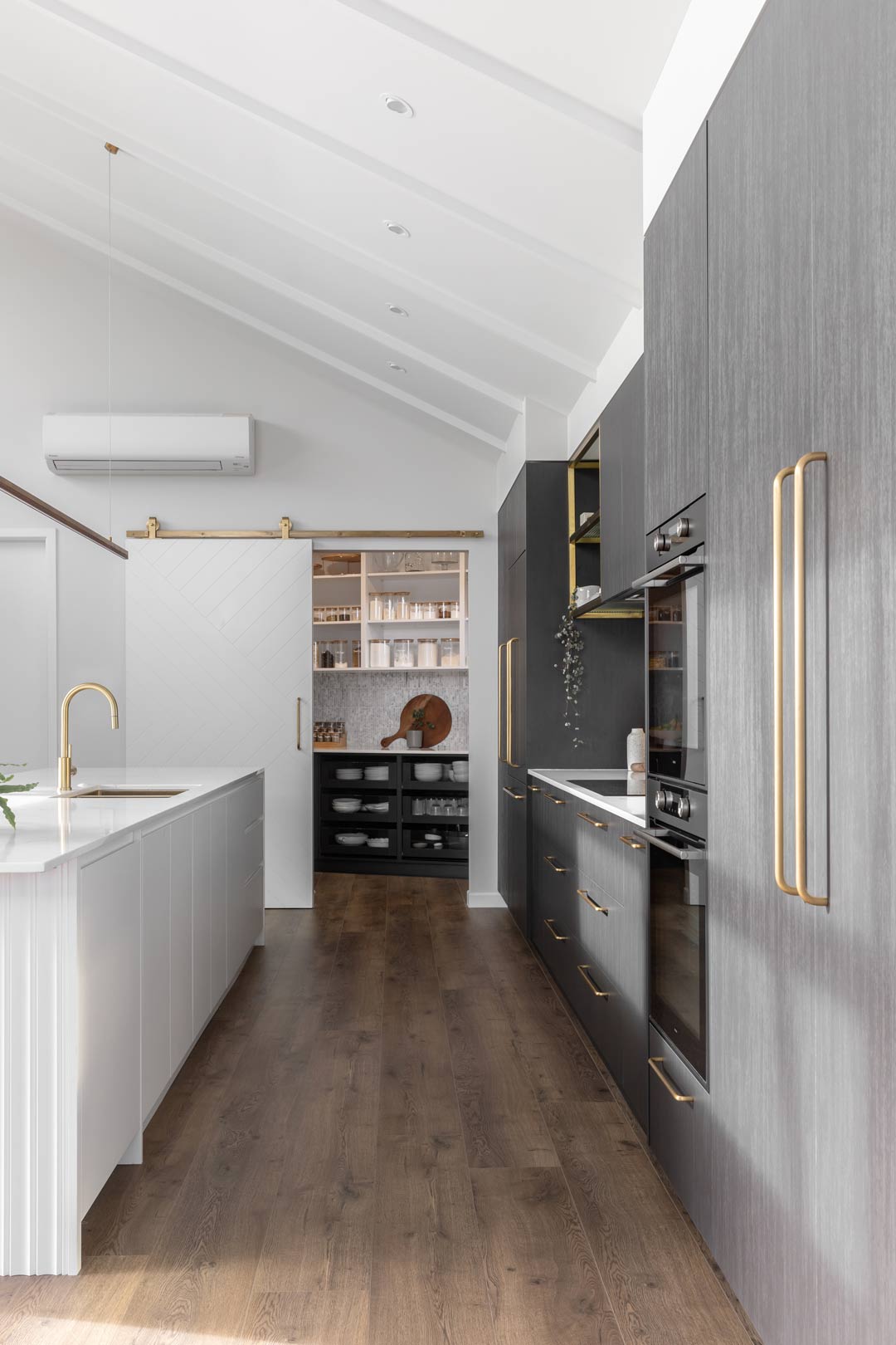 A-neat-tidy-kitchen-with-a-butlers-pantry-filled-with-labled-glass-jars-and-containers-to-keep-your-pantry-organised
