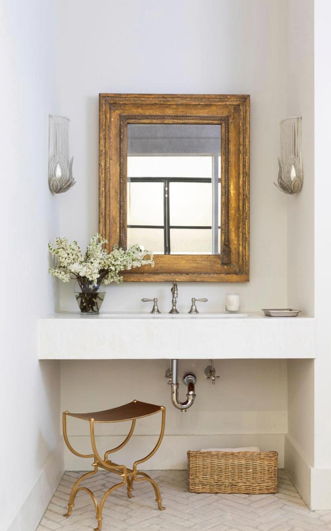 An-antique-gold-mirror-and-art-deco-wall-sconces-pair-with-chrome-tapware