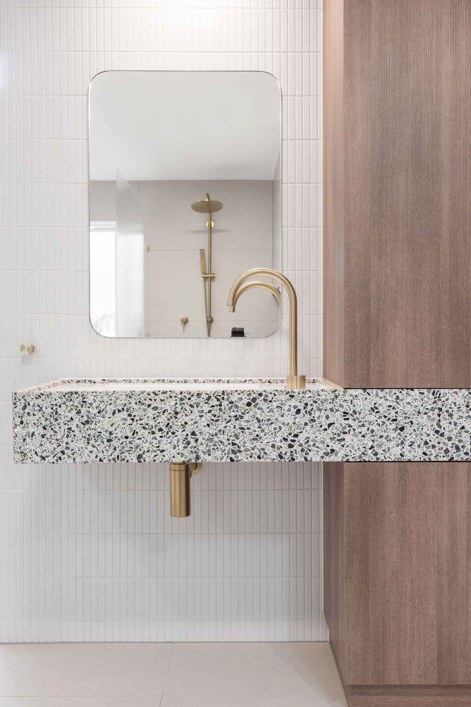 Brass-gooseneck-spout-with-round-square-mirror-and-kitkat-tiles