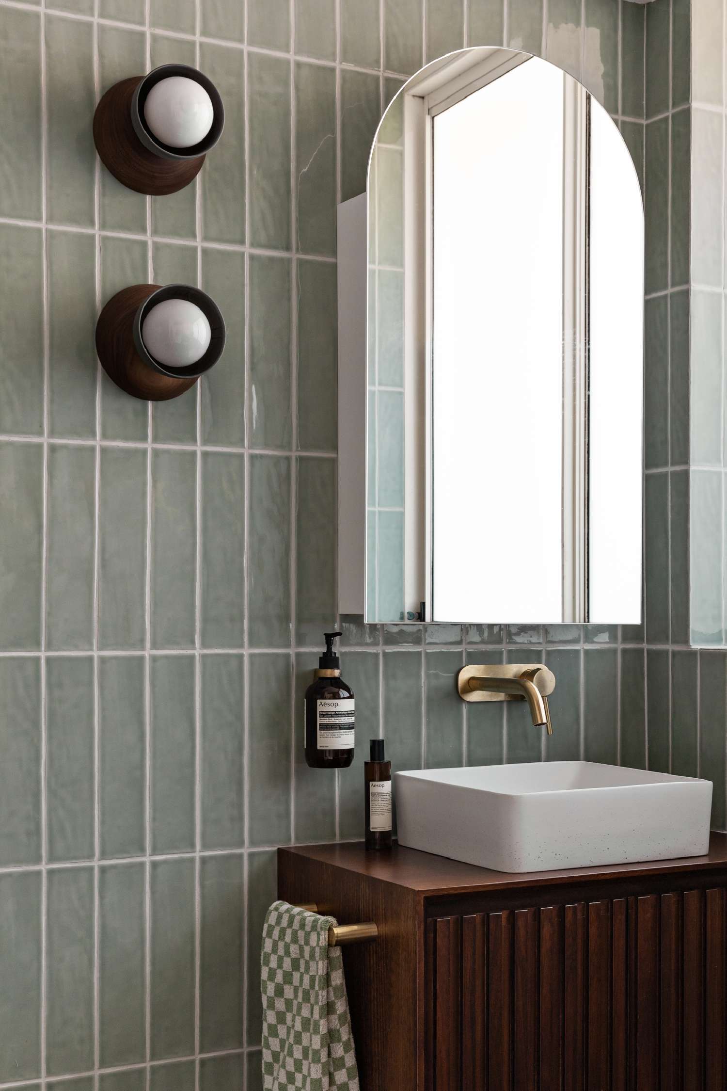 Brass-tapware-in-green-bathroom