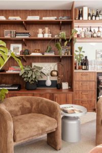 Earthy-colour-furniture-with-walnut-cabinetry-and-decorative-plants