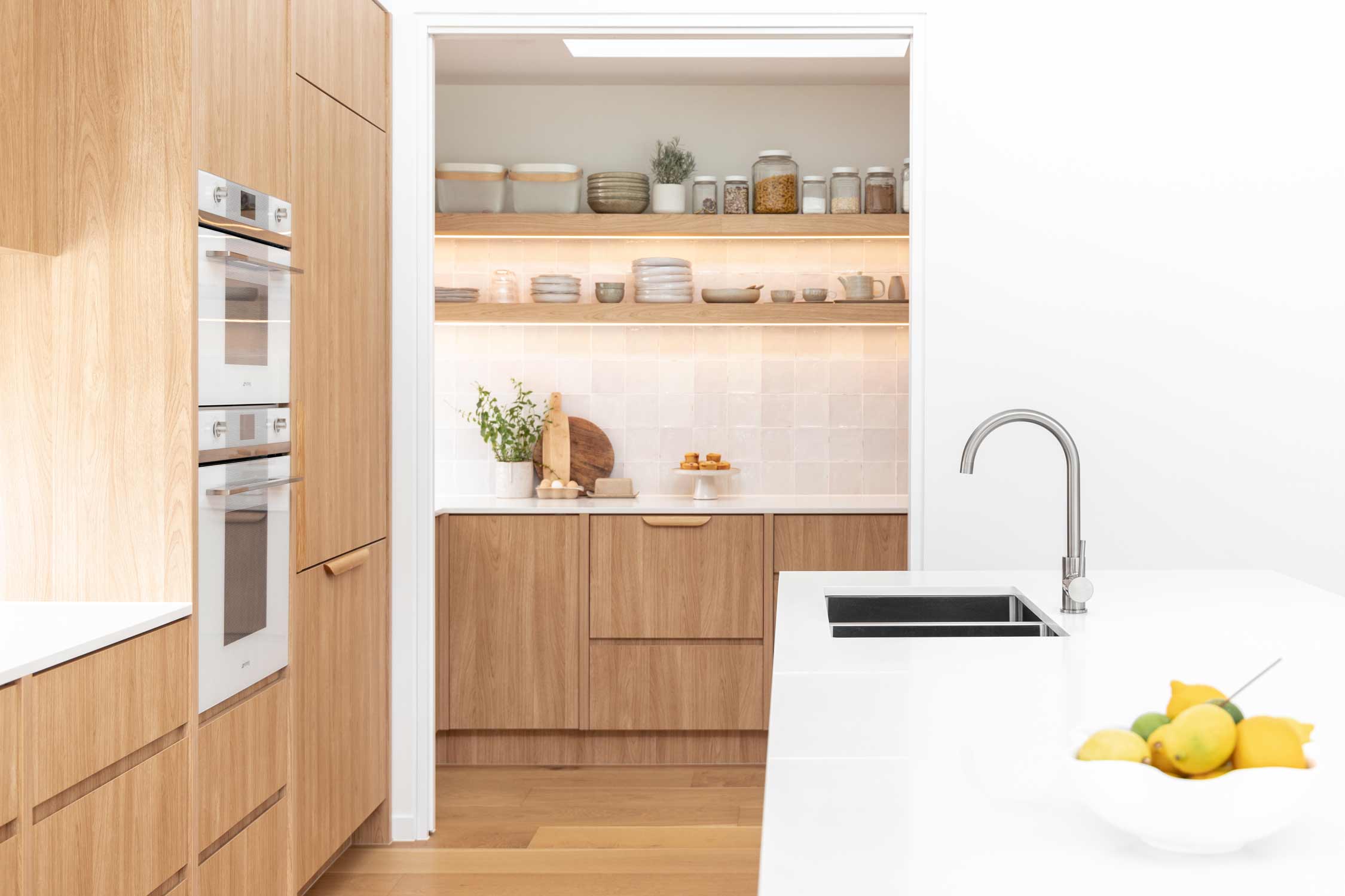 Hidden-home-coffee-bar-in-modern-coastal-home-butlers-pantry-warm-cabinetry-and-brushed-nickel-tapware