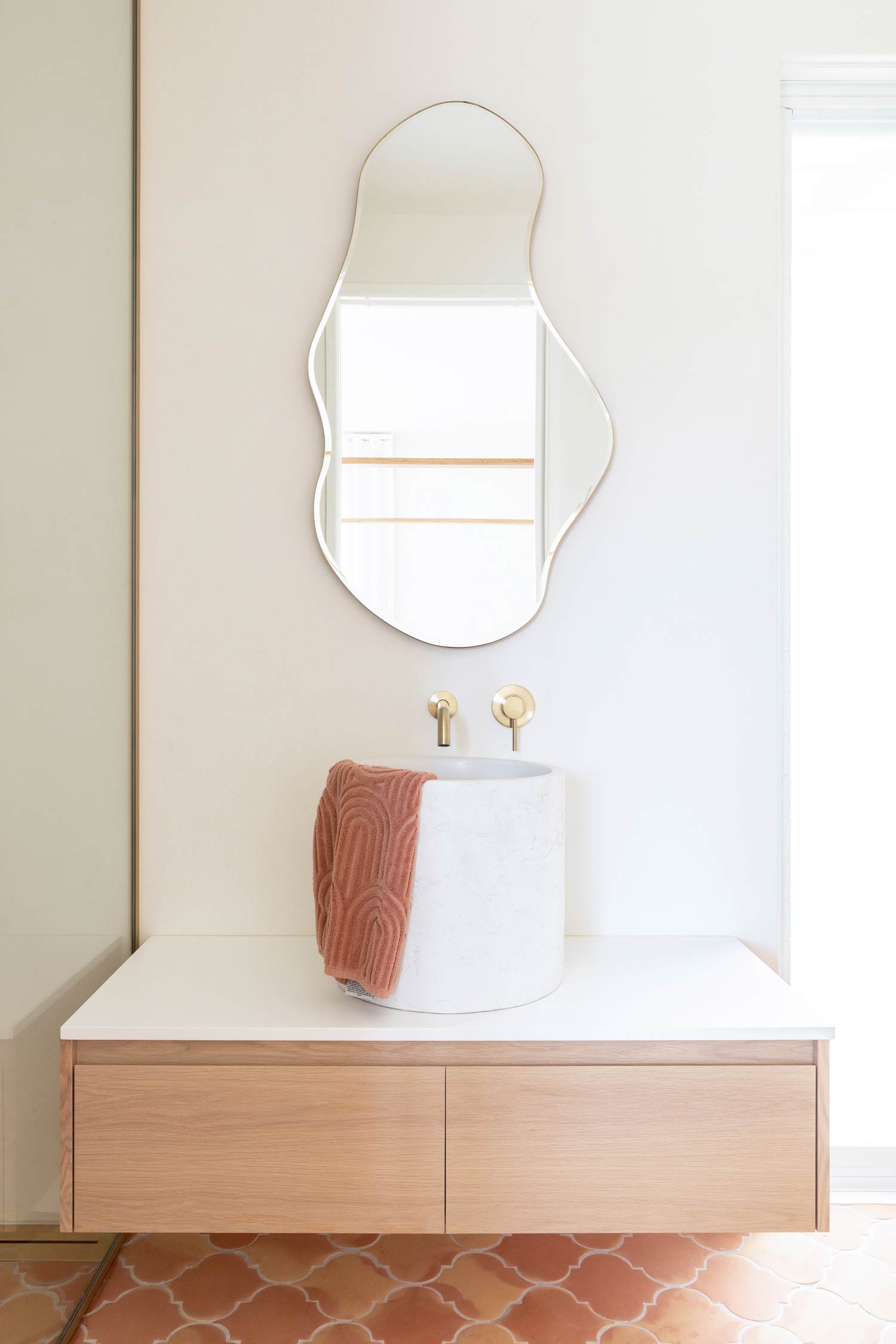 Kitchen-styling-ideas-for-a-moditerranean-home-inclue-brushed-brass-tapware-terracotta-tiles-raw-concrete-basin-and-a-neutral-colour-palette