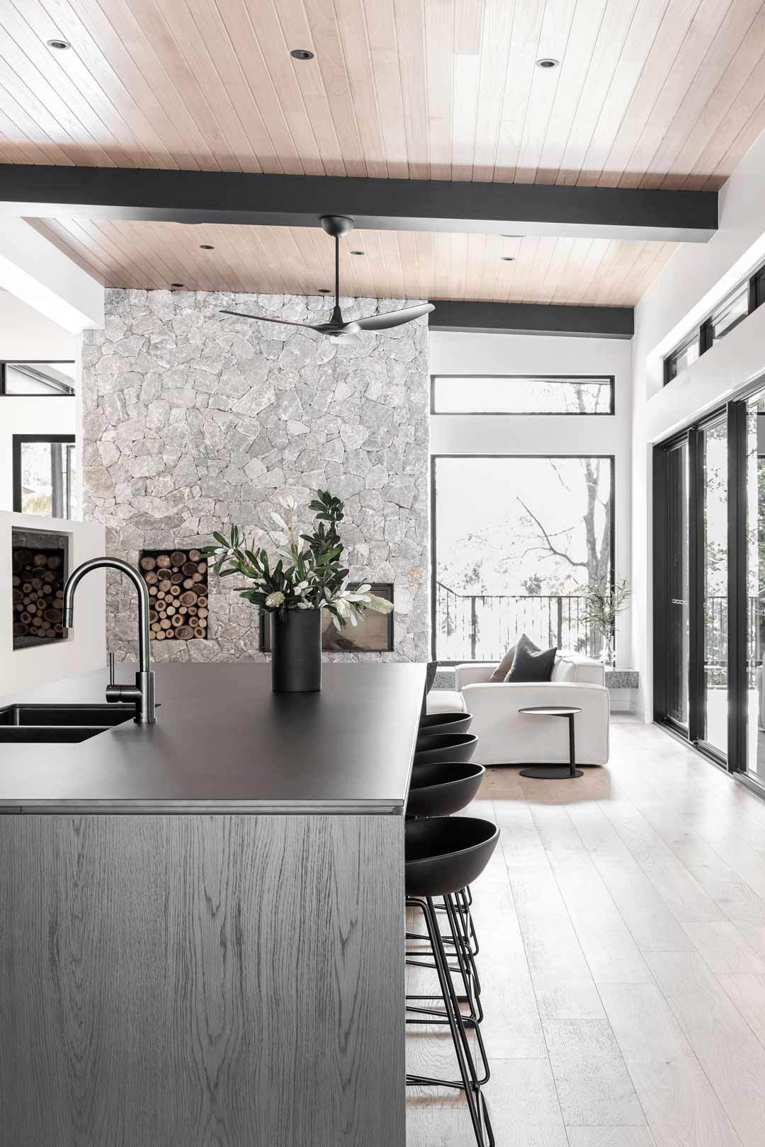 Monochromatic-kitchen-looking-into-the-entertaining-area-of-an-alpine-lodge-style-home-Kooringal-Lodge