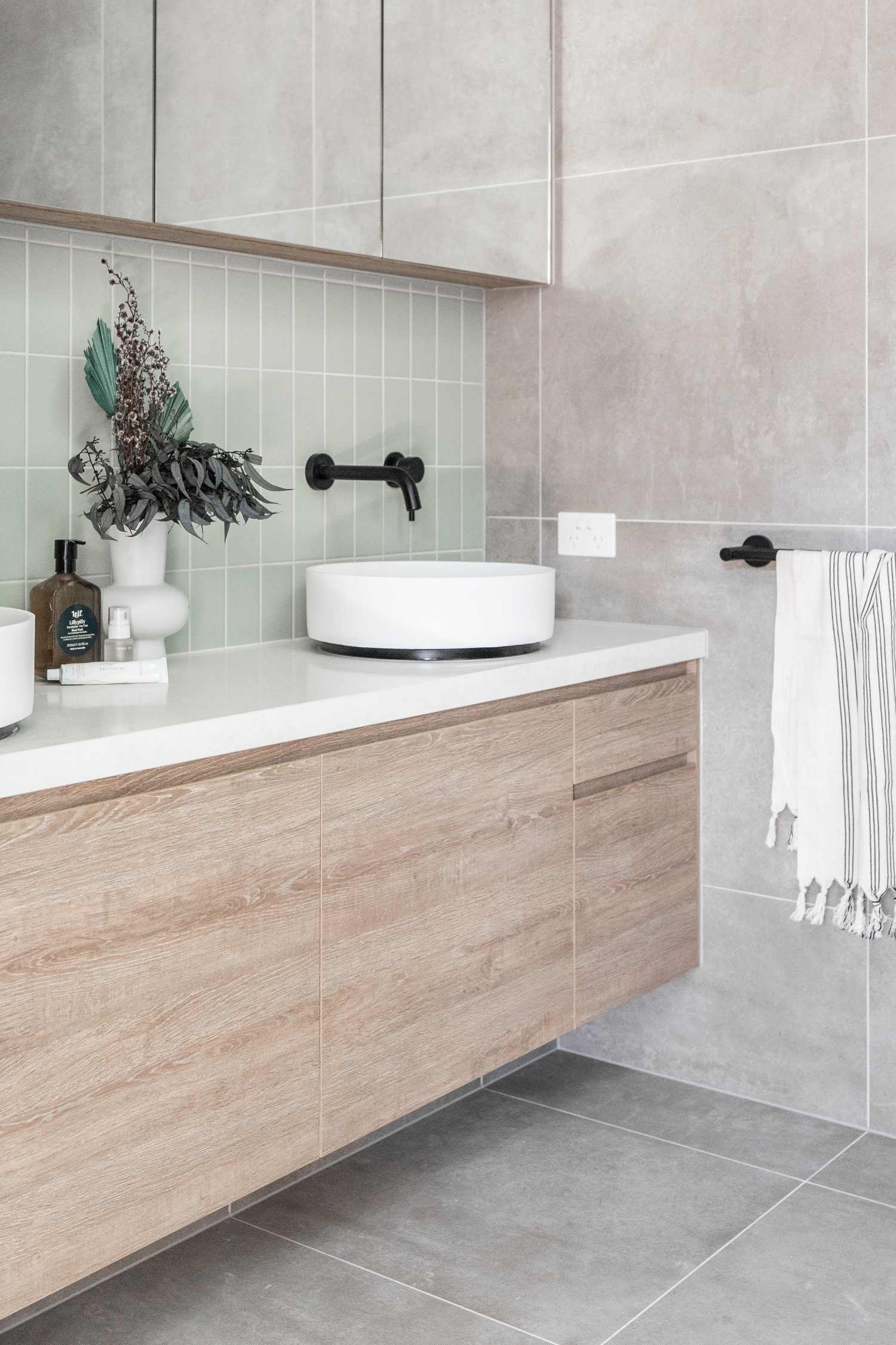 Pastel-mint-green-tiles-and-matte-black-tapware