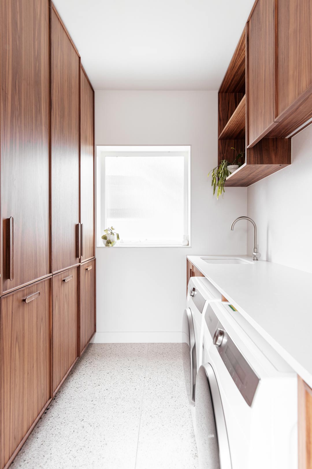 Small-narrow-laundry-ideas-creating-a-clean-space-using-cupboard-storage-both-sides-with-a-hanging-drying-rail-and-shelves