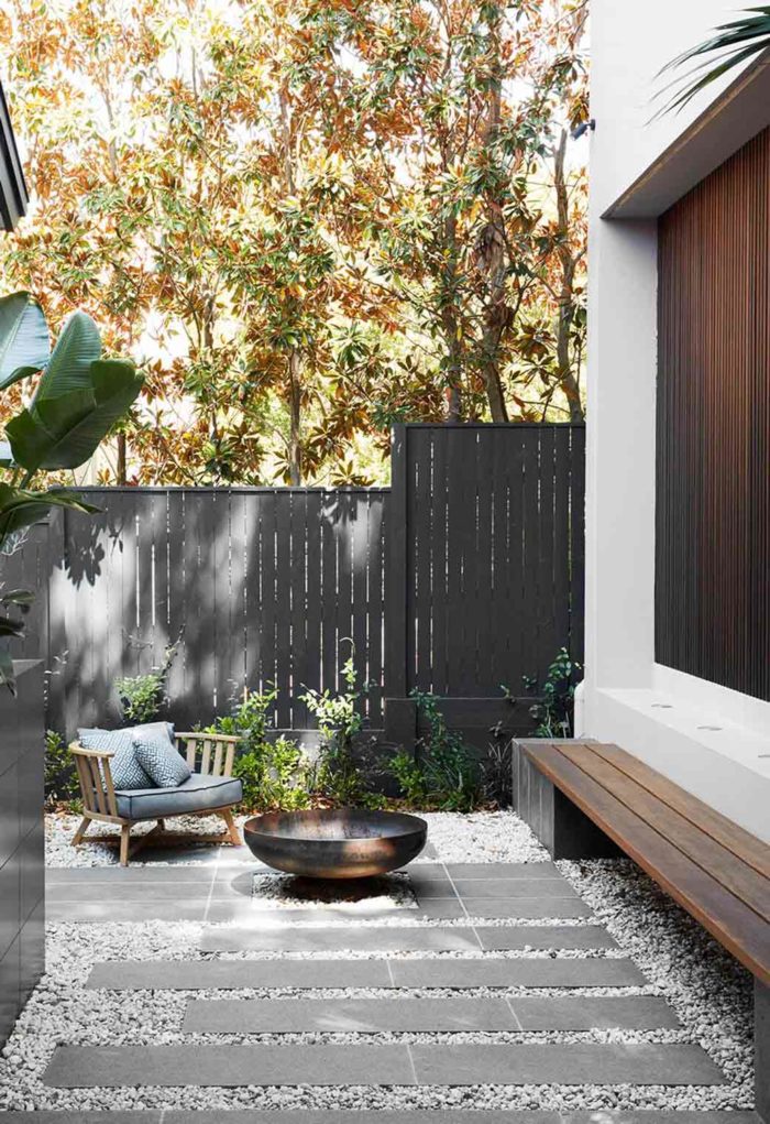 Small-patio-ideas-patio-outdoor-fireplace-with-outdoor-furniture-timber-dark-fence-stone-and-pavers-700x1021