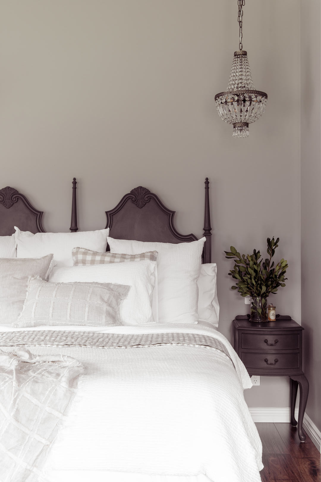 Soft-sage-green-walls-and-dark-timber-paired-with-a-chandelier-and-neutral-layered-bed-linens-in-this-bedroom-bring-a-modern-twist-on-old-money-aesthetic-home-decor