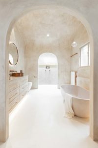 mediterranean bathroom with archway and textured walls