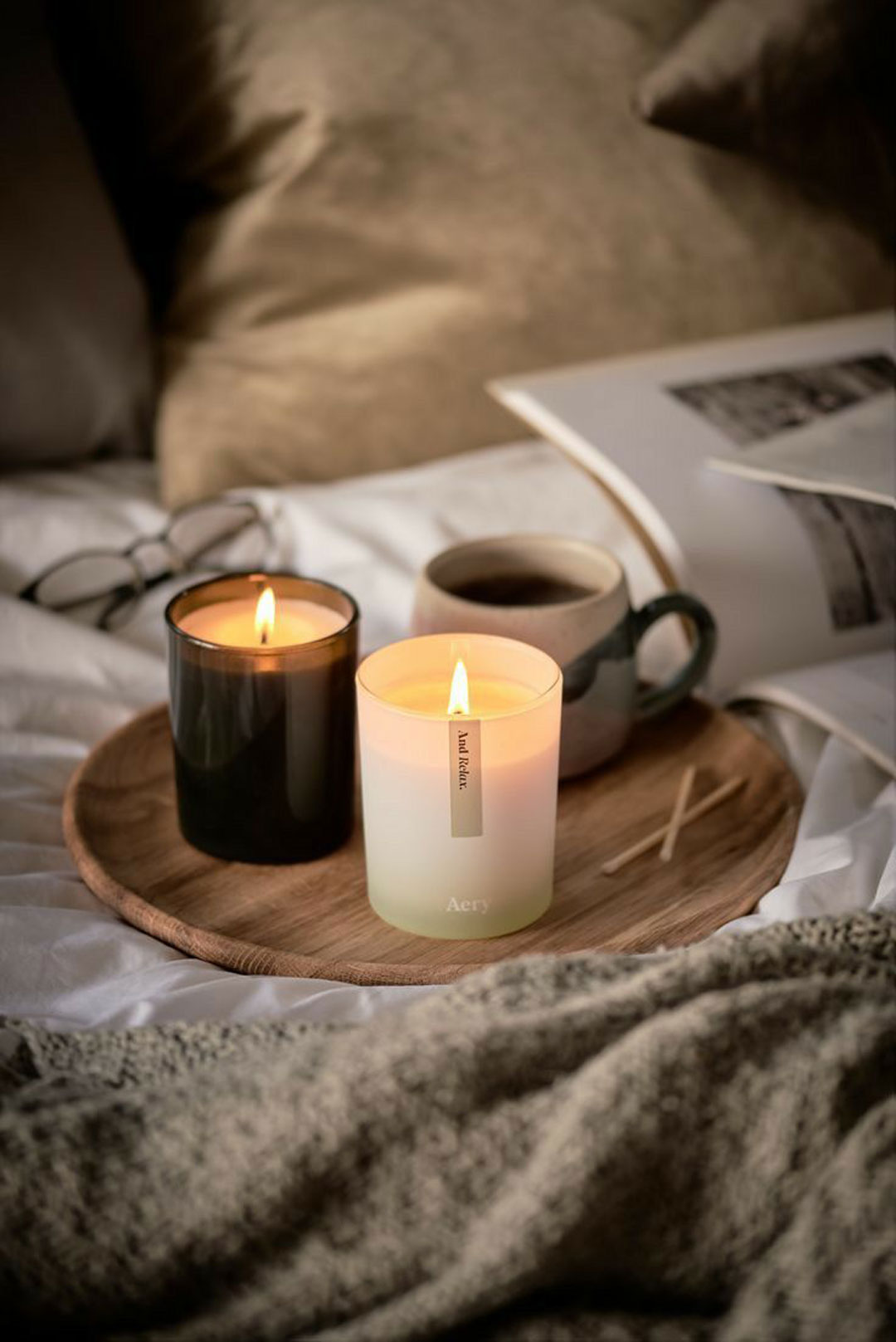 the-meaning-of-hygge-explained-in-this-cosy-image-of-layered-soft-fabrics-and-candles-and-warm-coffee